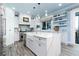 Bright kitchen with large island, white cabinetry, modern appliances, and ocean views at 1373 N Atlantic Ave, New Smyrna Beach, FL 32169