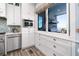 Bright kitchen featuring stainless steel appliances, tile backsplash, and a window with ocean views at 1373 N Atlantic Ave, New Smyrna Beach, FL 32169