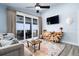 Bright living room boasts ocean views, stylish decor, and a unique wood console table, perfect for relaxing at 1373 N Atlantic Ave, New Smyrna Beach, FL 32169