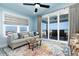 Cozy living room with ocean view, comfortable seating, and vibrant rug creates an inviting space to unwind at 1373 N Atlantic Ave, New Smyrna Beach, FL 32169