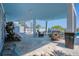 Expansive outdoor patio with multiple seating areas, spiral staircase, and pool view at 1373 N Atlantic Ave, New Smyrna Beach, FL 32169