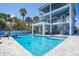 Home exterior with outdoor pool, volleyball net and lounge area with multiple seating arrangements at 1373 N Atlantic Ave, New Smyrna Beach, FL 32169