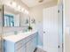 Bathroom featuring a modern vanity, stylish mirror, and ample lighting at 16 Hillside Dr, New Smyrna Beach, FL 32169