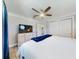 Relaxing main bedroom with ceiling fan, dresser with TV, and ensuite bathroom access at 16 Hillside Dr, New Smyrna Beach, FL 32169