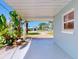 View of the home across a driveway and through the covered carport area at 16 Hillside Dr, New Smyrna Beach, FL 32169