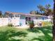 Home exterior with backyard patio, an outdoor shower, and lush lawn at 16 Hillside Dr, New Smyrna Beach, FL 32169
