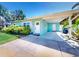 A covered driveway complements the clean lines and white accents of this home's exterior at 16 Hillside Dr, New Smyrna Beach, FL 32169