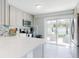 Contemporary kitchen with white countertops, stainless steel appliances, and natural lighting at 16 Hillside Dr, New Smyrna Beach, FL 32169