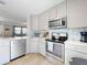 Bright kitchen with stainless steel appliances, white countertops, and blue backsplash at 16 Hillside Dr, New Smyrna Beach, FL 32169