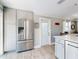 Spacious kitchen features stainless steel refrigerator and an adjacent dining area at 16 Hillside Dr, New Smyrna Beach, FL 32169