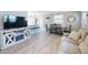 Open-concept living space with modern furnishings and a view into the dining area and kitchen at 16 Hillside Dr, New Smyrna Beach, FL 32169