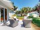 Outdoor patio features seating area, lush lawn, shed and slider to the home's interior at 16 Hillside Dr, New Smyrna Beach, FL 32169