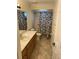 Bathroom featuring a single sink vanity, tub and shower combo and plenty of light at 1629 Travelers Palm Dr, Edgewater, FL 32132