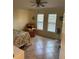Comfortable bedroom with neutral walls, tile flooring, a ceiling fan and great natural light at 1629 Travelers Palm Dr, Edgewater, FL 32132