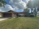 Charming single-story home with a well-maintained lawn and stone accents on the facade at 1629 Travelers Palm Dr, Edgewater, FL 32132