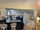 Kitchen featuring white cabinets and a breakfast bar, creating a functional cooking space at 1629 Travelers Palm Dr, Edgewater, FL 32132