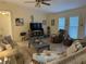 Bright living room featuring tile floors, a ceiling fan, and neutral decor for a comfortable space at 1629 Travelers Palm Dr, Edgewater, FL 32132