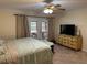 Serene main bedroom with access to the outdoors through glass doors at 1629 Travelers Palm Dr, Edgewater, FL 32132
