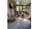 Cozy sun room features a ceiling fan, tiled floor, and comfortable wicker furniture at 1629 Travelers Palm Dr, Edgewater, FL 32132