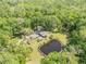 Picturesque land with pond surrounded by mature trees, creating a private retreat at 1663 Hideaway Ln, Edgewater, FL 32132