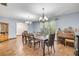 Traditional dining room featuring a large dining table, wood floors, and decorative chandelier lighting at 1663 Hideaway Ln, Edgewater, FL 32132