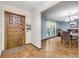 Inviting entryway with a wood door, tiled floor, opening to a dining area with natural light at 1663 Hideaway Ln, Edgewater, FL 32132