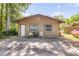 Front exterior view of a property featuring a shed, covered parking, and a concrete driveway at 1663 Hideaway Ln, Edgewater, FL 32132
