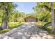 Inviting exterior showcasing the home's facade, complemented by a long driveway, and mature landscaping at 1663 Hideaway Ln, Edgewater, FL 32132