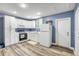 Modern white kitchen featuring sleek countertops, appliances, and ample cabinet space at 1663 Hideaway Ln, Edgewater, FL 32132