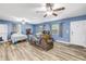 Bright and airy living room featuring hardwood floors, a ceiling fan, and natural light at 1663 Hideaway Ln, Edgewater, FL 32132