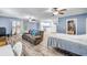 Open-concept living room with hardwood floors, ceiling fans, and a versatile living space at 1663 Hideaway Ln, Edgewater, FL 32132
