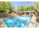 Scenic backyard pool with a patio umbrella, and ample space for outdoor entertaining at 1663 Hideaway Ln, Edgewater, FL 32132