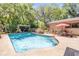 View of a backyard pool with attached patio, grill, and lush landscaping at 1663 Hideaway Ln, Edgewater, FL 32132