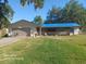 Single-story home featuring a two-car garage, a spacious lawn, and a covered front porch at 168 N Cory Dr, Edgewater, FL 32141