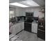 Bright kitchen with white cabinets, stainless steel appliances, and a window above the sink at 168 N Cory Dr, Edgewater, FL 32141