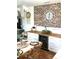 Elegant dining area with a brick wall, wine fridge and table set for a cozy dinner at 181 Caryota Ct, New Smyrna Beach, FL 32168