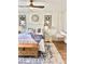 Cozy bedroom featuring a ceiling fan, decorative pillows, a hanging swing chair, and a decorative rug at 181 Caryota Ct, New Smyrna Beach, FL 32168