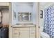 Bright bathroom features granite counters, a large mirror, and a spacious closet for storage at 1855 Pine Tree Dr, Edgewater, FL 32141