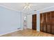 Bedroom featuring wood-look floors, two closets, and blue walls at 1855 Pine Tree Dr, Edgewater, FL 32141