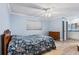 Bedroom featuring wood-look floors, blue walls and ensuite bathroom at 1855 Pine Tree Dr, Edgewater, FL 32141
