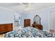 Bedroom featuring wood-look floors, blue walls and ensuite bathroom at 1855 Pine Tree Dr, Edgewater, FL 32141