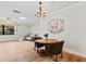 Elegant dining area with wood floors, stylish chandelier, and easy access to the living room at 1855 Pine Tree Dr, Edgewater, FL 32141