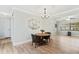 Cozy dining room with wood floors, decorative chandelier, and comfortable seating at 1855 Pine Tree Dr, Edgewater, FL 32141