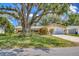 Charming single-story home with a well-manicured lawn, mature landscaping, and attached garage at 1855 Pine Tree Dr, Edgewater, FL 32141