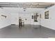 Spacious two-car garage with epoxy flooring, storage shelves, and a utility sink at 1855 Pine Tree Dr, Edgewater, FL 32141