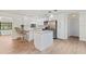Modern kitchen with white cabinetry, stainless steel appliances, and a breakfast bar at 1855 Pine Tree Dr, Edgewater, FL 32141