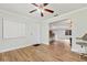 Open-concept living area with wood-look floors, a ceiling fan and bar seating at 1855 Pine Tree Dr, Edgewater, FL 32141