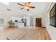 Open-concept living area with wood floors, island seating, and updated kitchen in view at 1855 Pine Tree Dr, Edgewater, FL 32141
