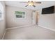 Bright bedroom featuring a ceiling fan, tile flooring, a window, and a mounted television at 1868 Pine Tree Dr, Edgewater, FL 32141