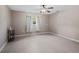 Bedroom featuring tile floors, a ceiling fan, and natural light through a window with curtains at 1868 Pine Tree Dr, Edgewater, FL 32141